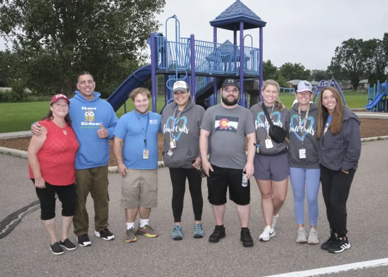 A group of volunteers pose at playground of a school for the Back to Class Bash.