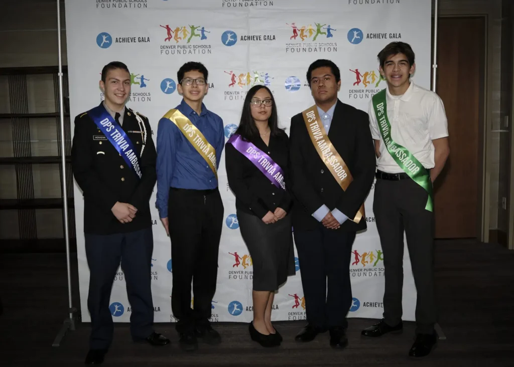 Five students wear sashes that read "DPS Trivia Ambassador" at the 2024 Achieve Gala