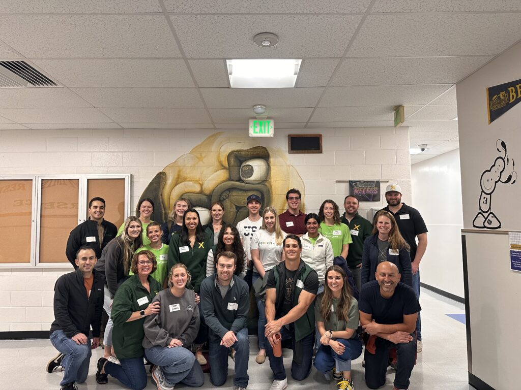Group of BPX Energy volunteers posing together inside a Denver Public Schools building.