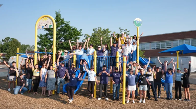 A group of volunteers at a school parking lot