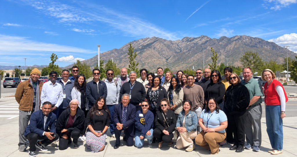 Group photo of 4 Corners Latinx Leadership Academy participants posing outdoors with mountains in the background.